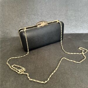 Black leather clutch with gold details